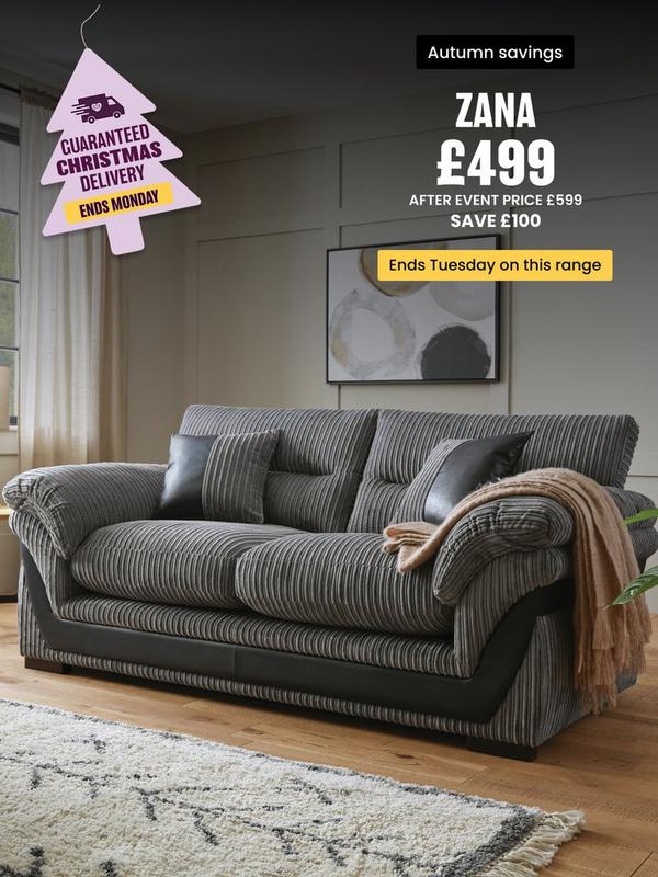 grey cord sofa with faux leather detailing on a wooden floored room setting