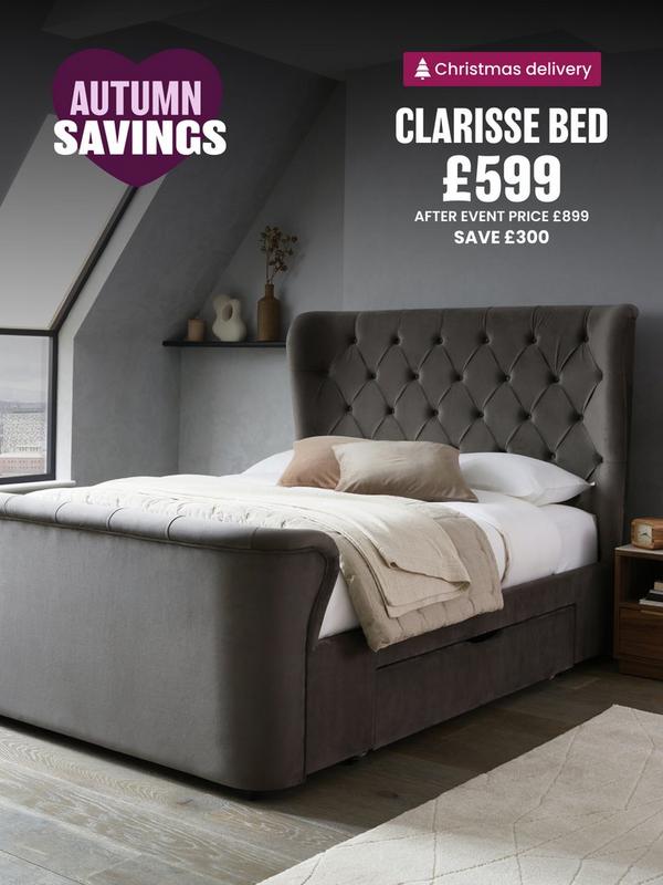 grey bed with squared edges on a panelled wall