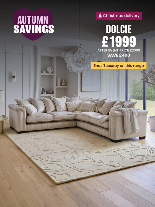 Cream corner sofa with pillow back on a cream rug