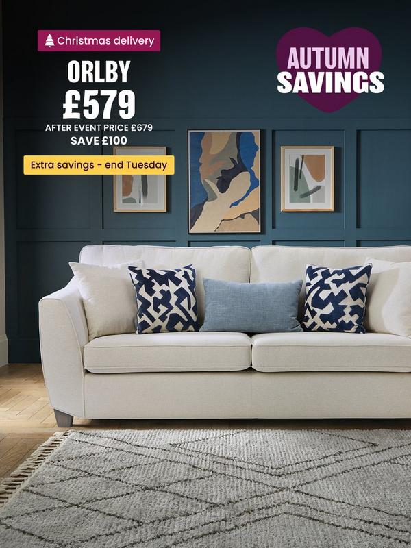 Cream corner sofa with pillow back on a cream rug