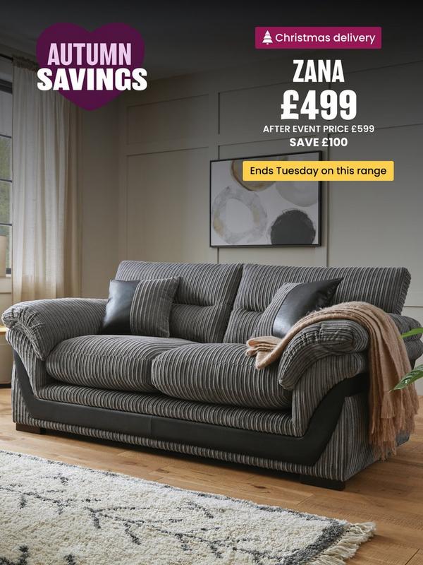 grey cord sofa with faux leather detailing on a wooden floored room setting