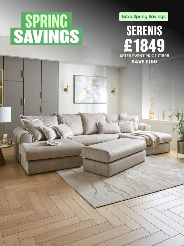 Cream sofa with matching footstool in front in a neutral living room 