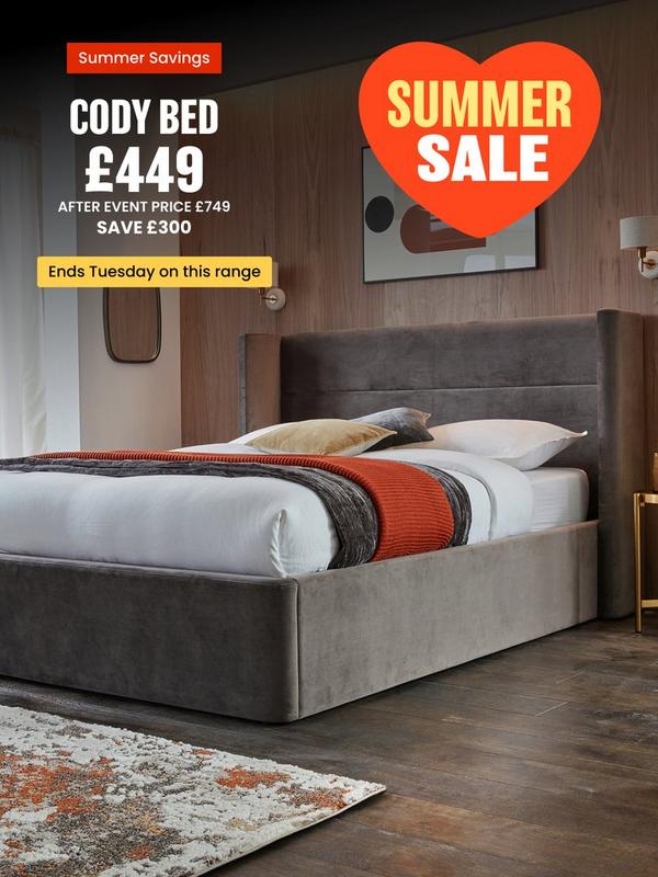 grey bed with straight edges on headcoard in a wooden panelled room