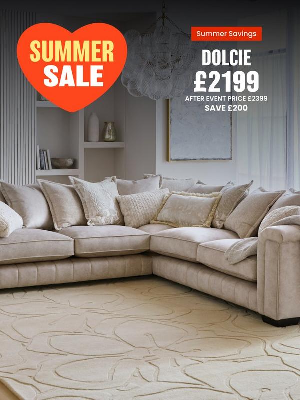 Cream corner sofa with pillow back on a cream rug