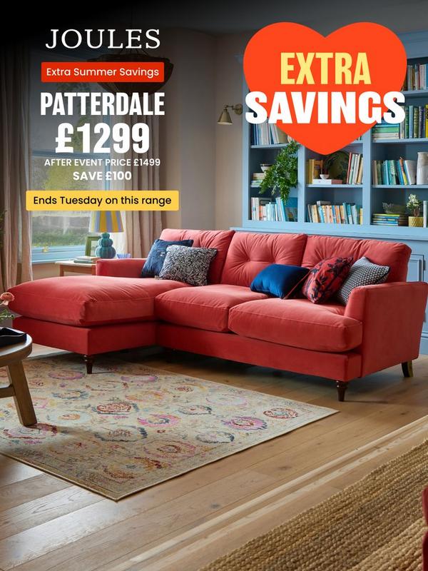 coral velvet chaise end sofa with contrasting navy scatter cushions