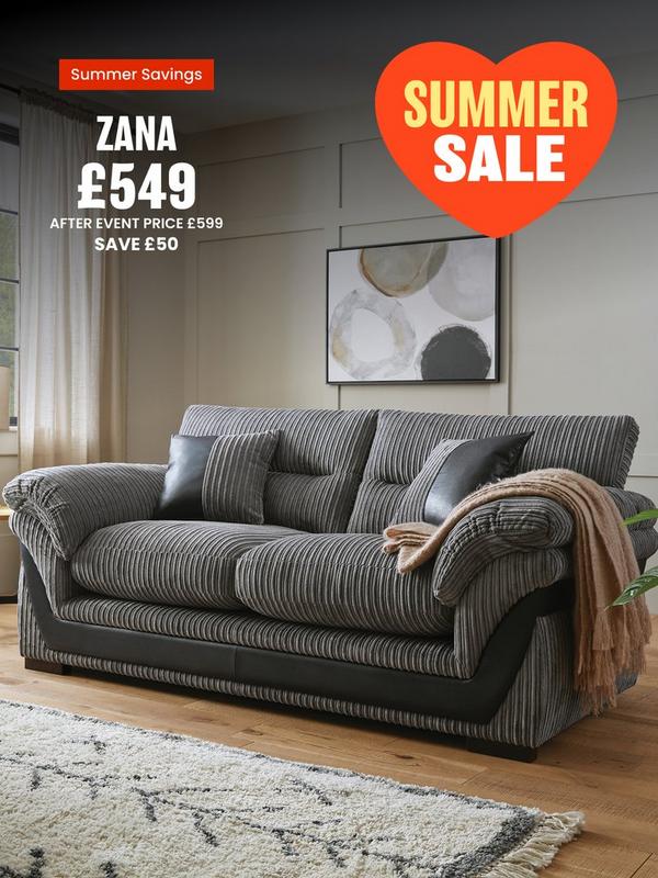 grey cord sofa with faux leather detailing on a wooden floored room setting