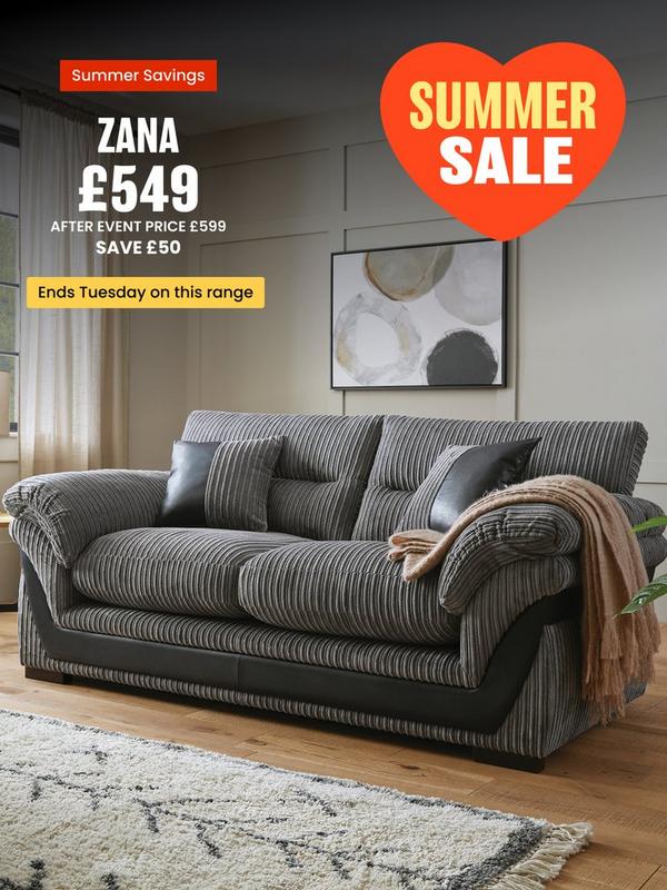 grey cord sofa with faux leather detailing on a wooden floored room setting
