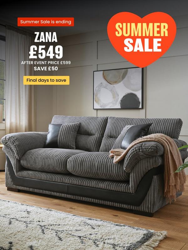 grey cord sofa with faux leather detailing on a wooden floored room setting