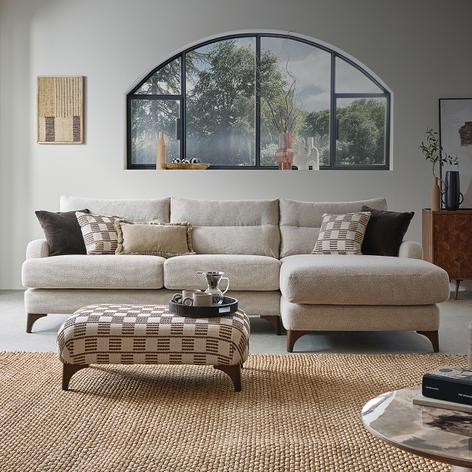 khaki sofa in a bright room with white scatter cushions