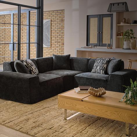 green compressed sofa with shelving unit on back wall