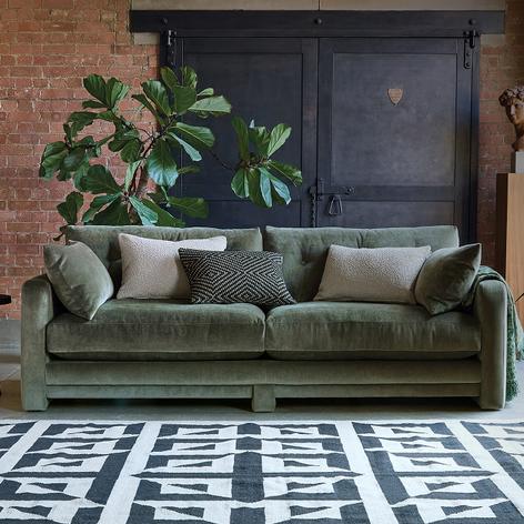 khaki sofa in monochrome rug and plant