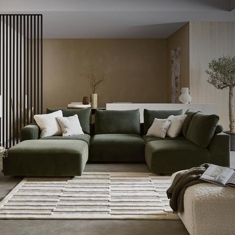 khaki sofa in a bright room with white scatter cushions