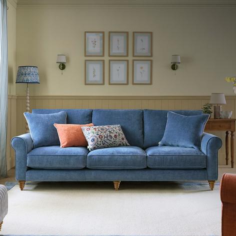 blue sofa with contrast scatter cushions on a waved edge rug