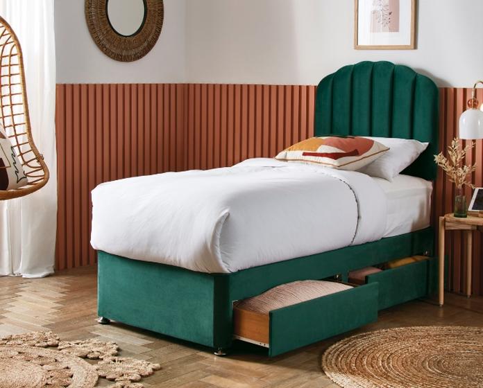 Green velvet single bed with wood wall panels and hanging basket style chair