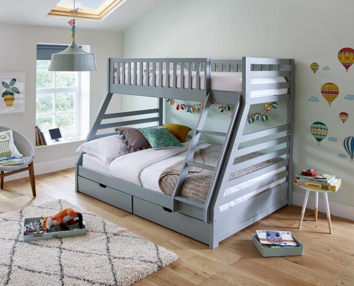 Grey bunk bed with a double bed on the bottom and double drawers in light green bedroom with laminate flooring