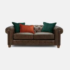 brown leather sofa with rust and green coloured scatter cushions