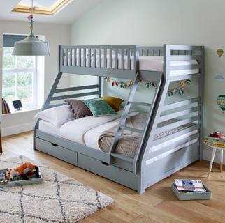 Grey bunk bed with a double bed on the bottom and double drawers in light green bedroom with laminate flooring