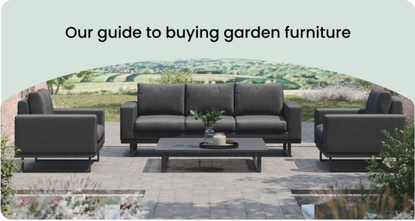 Dark grey sofa with matching chairs against a scenic outdoor background