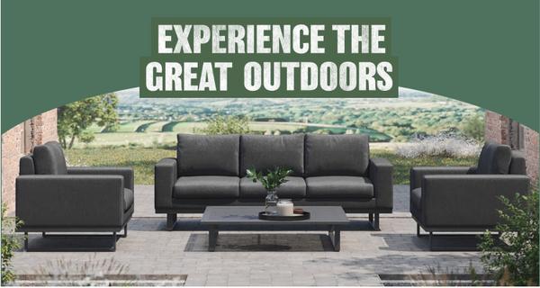 Dark grey sofa with matching chairs against a scenic outdoor background