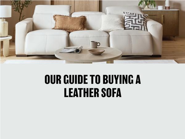 white leather recliner sofa with monochrome and brown scatter cushions