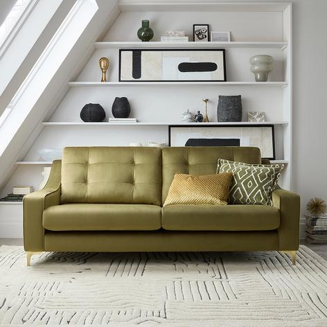 khaki sofa in velvet in a white room with monochrome accessories
