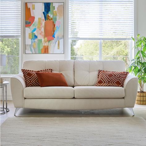 cream sofa with dark orange scatter cushions
