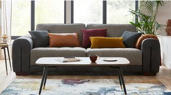 two tone fabric sofa with orange and red scatter cushions