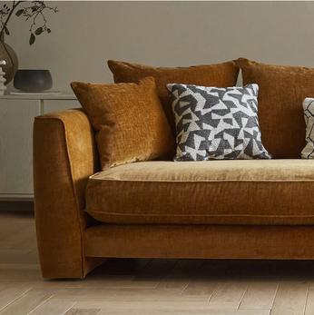 orange chenille sofa with orange and monochrome scatter cushions