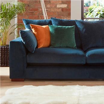 orange chenille sofa with orange and monochrome scatter cushions