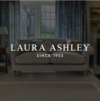 a cream sofa with a variety of different scatter cushions