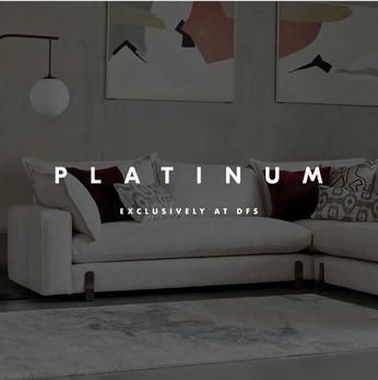 white corner sofa with red scatter cushions 