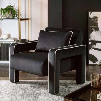black accent chair with white piping 