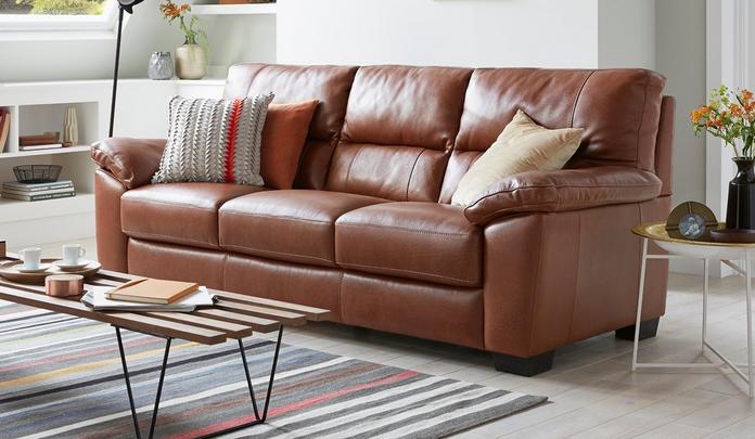 brown sofa with patterned scatter cushions on a stripy rug