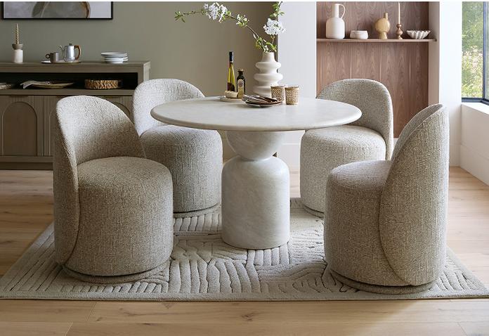 round marble dining with four grey boucle dining chairs
