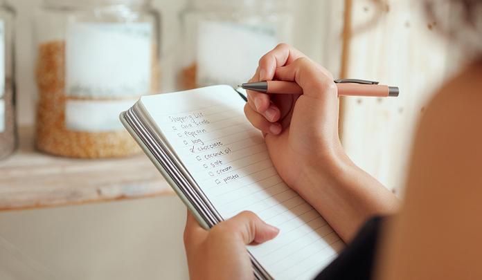 close up of a women writing a list