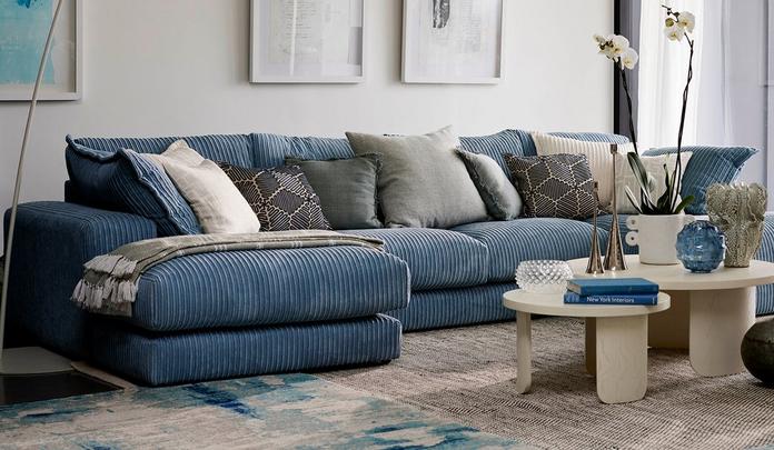 Blue jumbo cord double end chaise sofa with a variety of scatter cushions