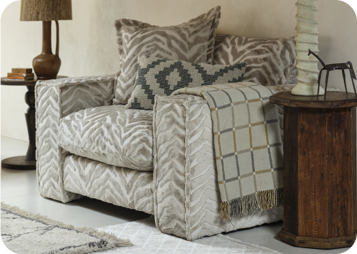 Zebra print chair with patterned cushion next to dark wood furniture