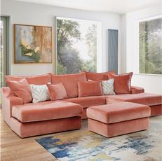 orange u shaped corner sofa with matching footstool on a colourful rug