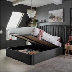 Dark grey velvet ottoman bed in a dark bedroom with black wallks and modern ceiling lighting