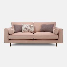 pink sofa with bolsters and patterned scatter cushions