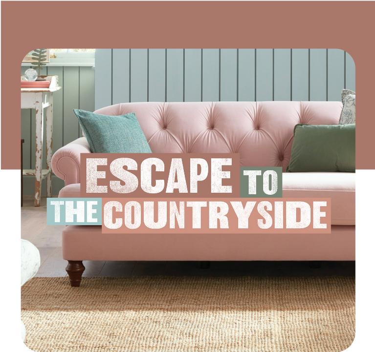 Pale pink Chesterfield sofa with studded button back finished with green scatter cushions
