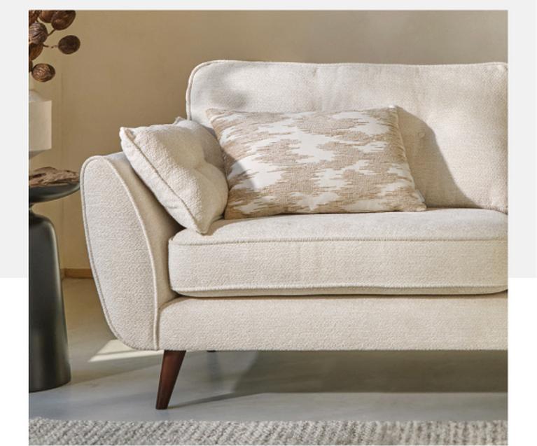 beige boucle mid century sofa with neutral cushions