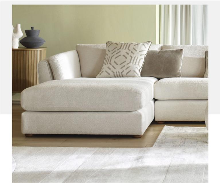cream double ended chaise chenille sofa with patterned and neutral scatter cushions alongisde a matching footstool