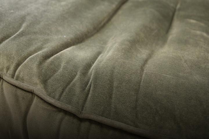 close up of a worn fabric sofa