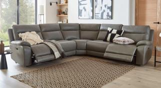dark brown leather corner sofa next to a brown patterened rug