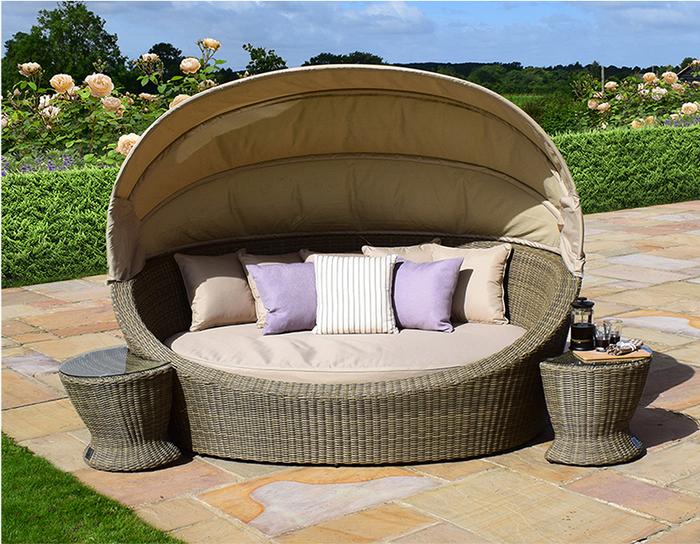 Beige rattan day bed with adjustable protective hood