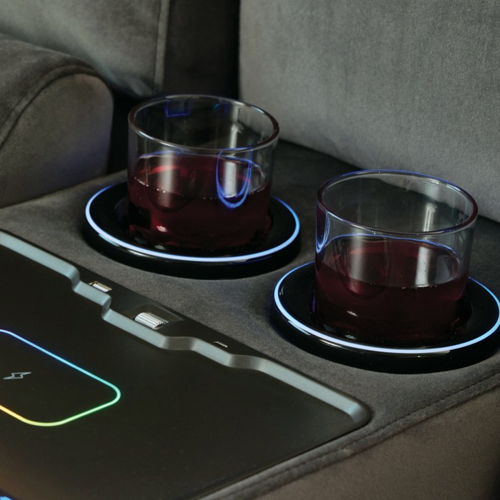 close up of a wireless charging and cup holders