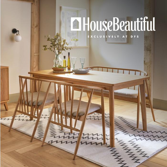 wooden table and four chairs with cushions on the seat