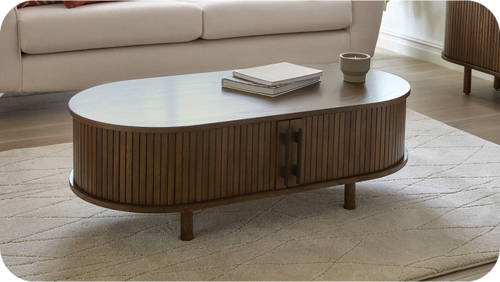 dark wood round coffee table with black metal handles