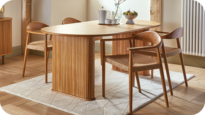 Wooden dining table with panelled legs and 4 wooden chairs